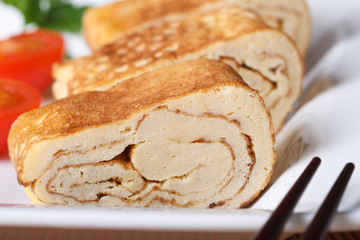 Japanese tamago egg on a white plate close-up. horizontal