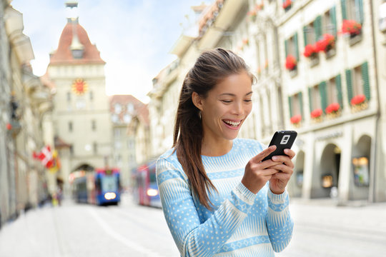 Woman on smart phone in Bern Switzerland