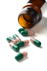 pills in pill bottle on white background