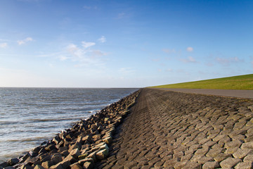 Solid dike rocks, boulders and grass