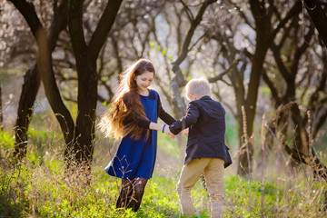 Fototapeta premium children walk in the park in spring