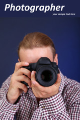 Handsome photographer with camera,on dark color background