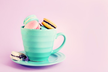 Assortment of gentle colorful macaroons in mug