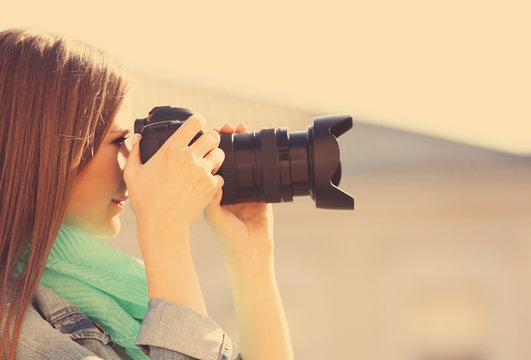 Young photographer taking photos outdoors