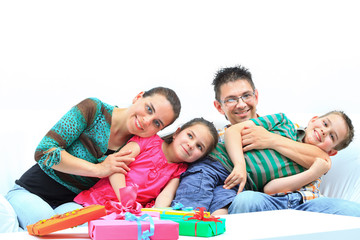 Happy cheering family in white room with presents