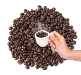 Cup of coffee beans on coffee beans background