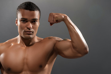 Young handsome African man posing shirtless