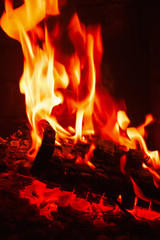 Fireplace burning. Warm burning and glowing fire in fireplace. - 76360732