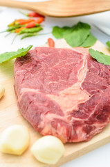 Raw Fresh Meat Slices on Wooden Chopping Board.
