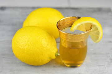 tea glass of lemon tea, on grey old wooden table