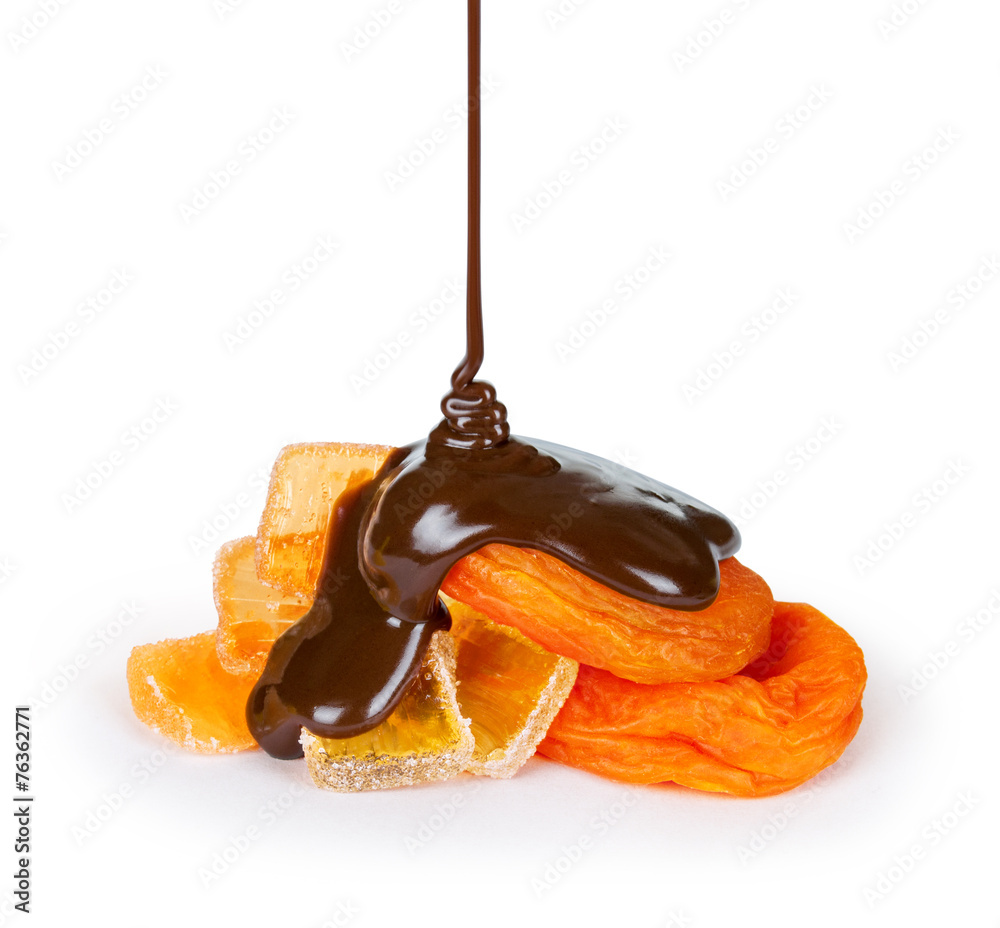 Wall mural feed chocolate pouring onto dried apricot and marmalade on white