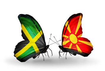 Fototapeta na wymiar Two butterflies with flags Jamaica and Macedonia