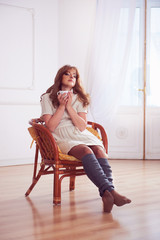 Young woman drinking coffee or tea