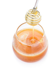 Fototapeta na wymiar Honey in jar with spoon isolated on white background