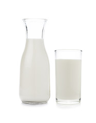 Glass and bottle of milk on white background