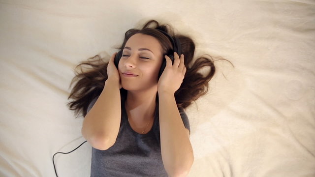Pretty Girl in Love Listening Music in Bed