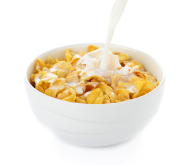 pouring milk into cornflakes bowl isolated on white - 76371796