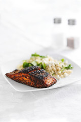 salmon filet with quinoa and arugala