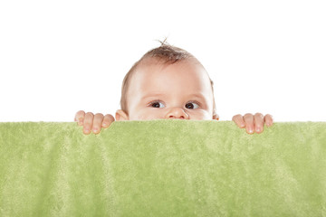 cute baby boy peek behind the green towel © vladimirfloyd