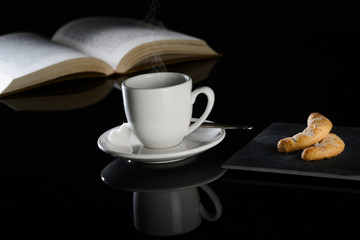 hot drink black espresso coffee with book and cookies