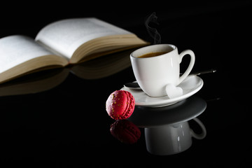 hot drink black espresso coffee with a book and macaroon