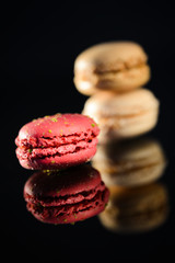 stack of colorful french macaroon on a black background
