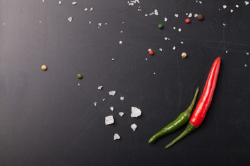 Red and green hot chilli pepper with sea salt and colored pepper
