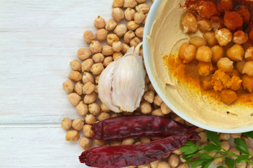 Hummus dish on a vintage wooden background