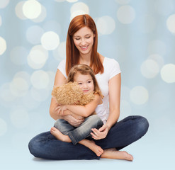 happy mother with adorable girl and teddy bear