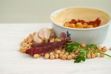 Chick peas and hummus dish on a vintage wooden background