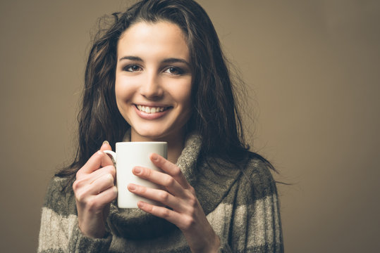 Beautiful woman having an hot drink