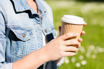 close up of young girl with coffee cup outdoors