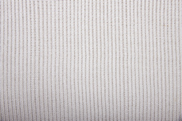 Fototapeta premium The texture of knitted fabric white, weaving braids.