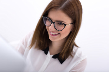 Closeup portrait of a young happy businesswoman in glasses