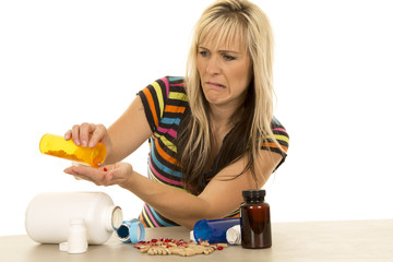 woman pouring pills into hand funny expression