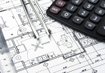 Construction blueprints and drawing instrument on the worktable