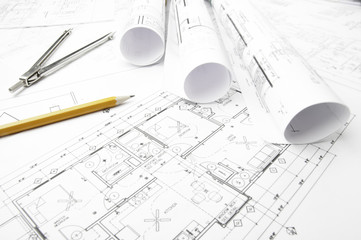 Construction blueprints and drawing instrument on the worktable