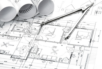 Construction blueprints and drawing instrument on the worktable