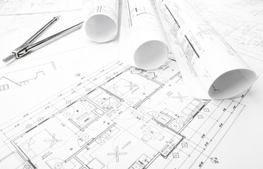 Construction blueprints rolled on the worktable