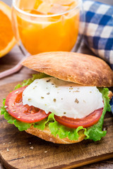 Burger with pouched egg and tomato