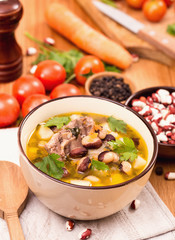 Bowl of bean soup with meat and ingredients