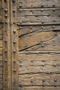 Wooden door with large iron nails