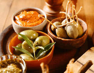 Bowls of olives with savory sauces