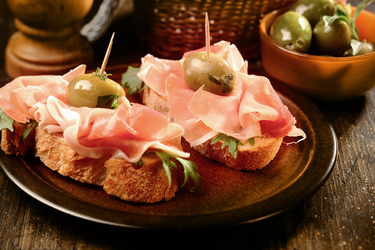 Canapes or tapas with proscuitto ham