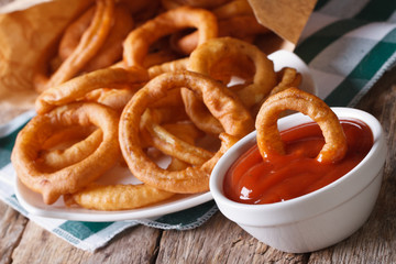 onion rings in tomato sauce closeup. horizontal on the table