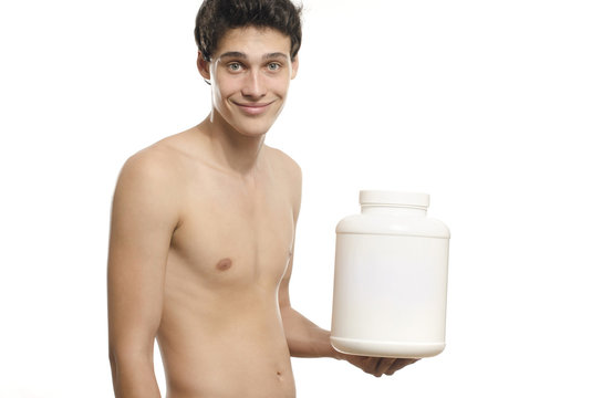 Skinny man training, drinking a protein shake, taking steroids