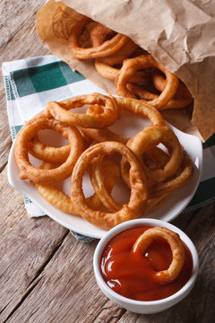 Fried onion rings and ketchup closeup. vertical top view