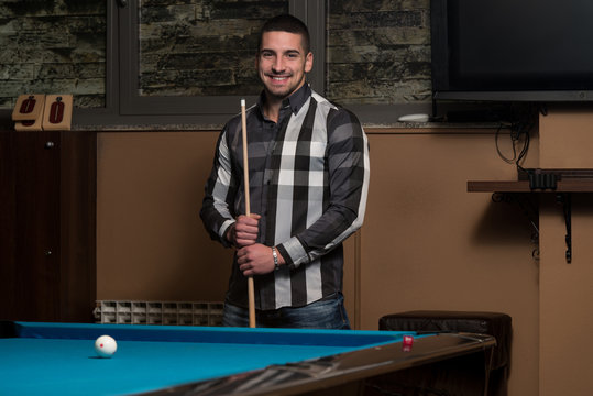 Portrait Of A Young Man Playing Billiards