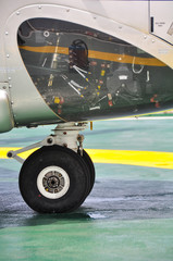 Wheel of airplane or helicopter parking on parking area.