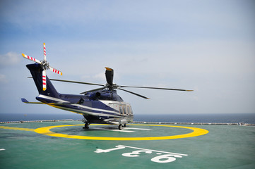 Helicopter parking on helideck and waiting passenger. © currahee_shutter